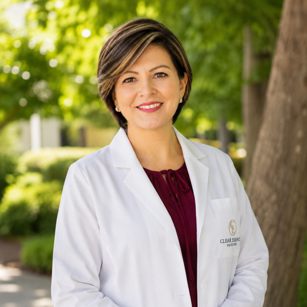 Smiling physician in a white coat outside a clinic