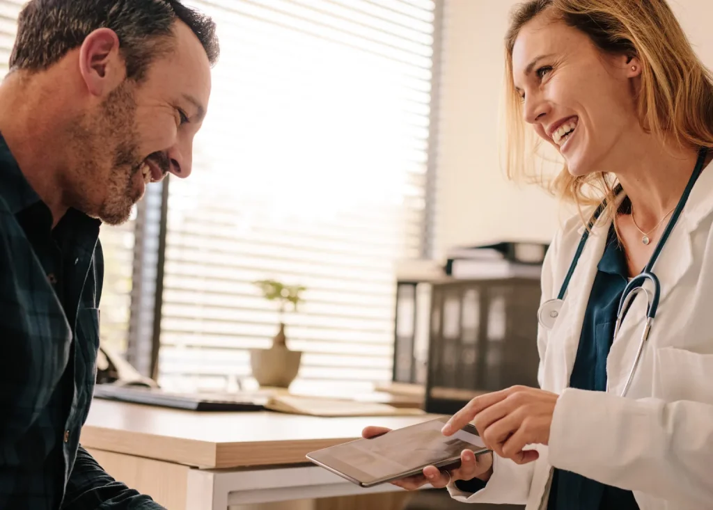 Doctor reviewing information with a patient at the front desk