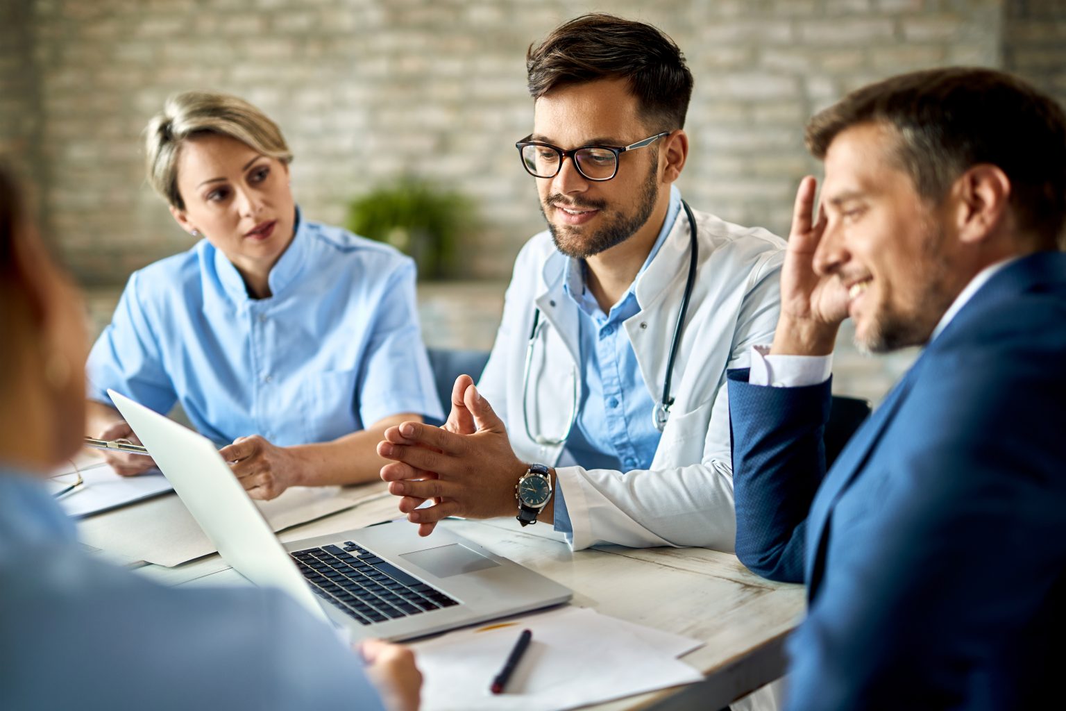 Healthcare team reviewing clinic marketing on a laptop